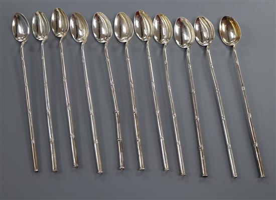 A set of eleven white metal bombilla? spoons.